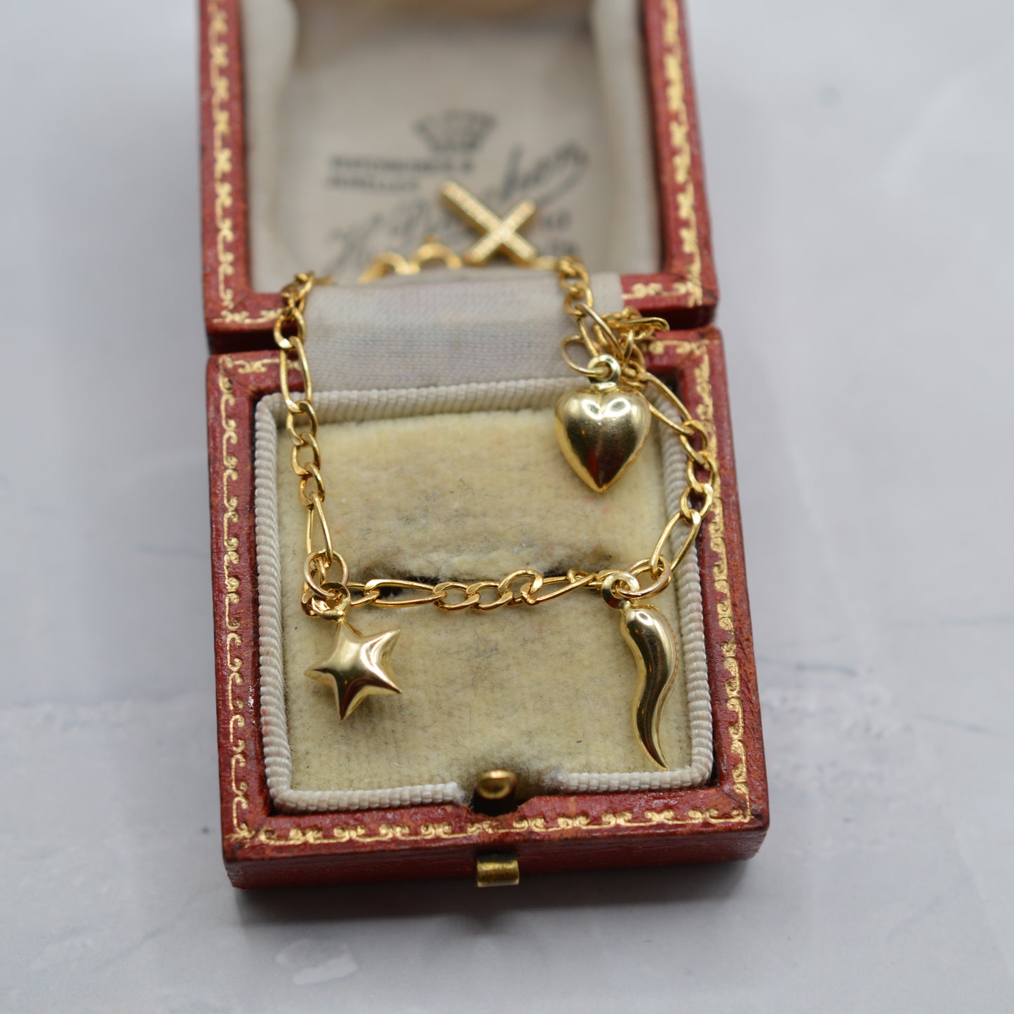 9ct Gold Five-Charm Figaro Bracelet (7”)