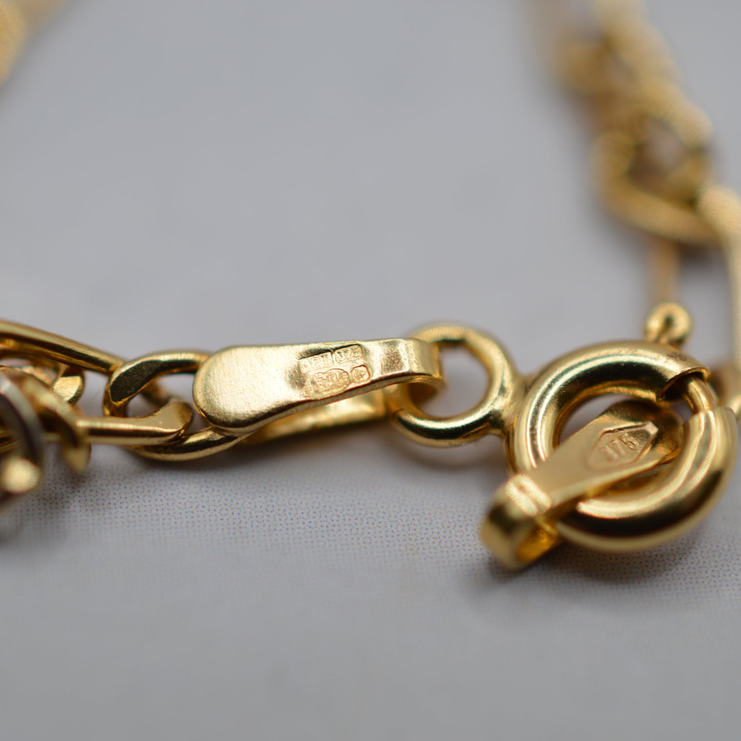 9ct Gold Five-Charm Figaro Bracelet (7”)