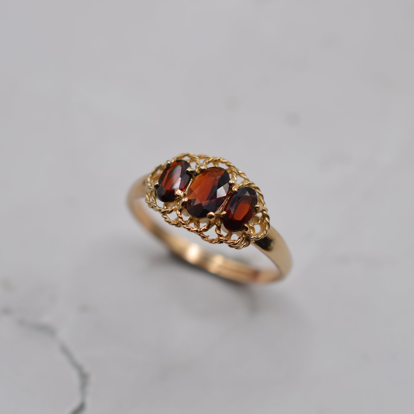 9ct Gold Garnet Trilogy Ring with Rope-Twist Frame