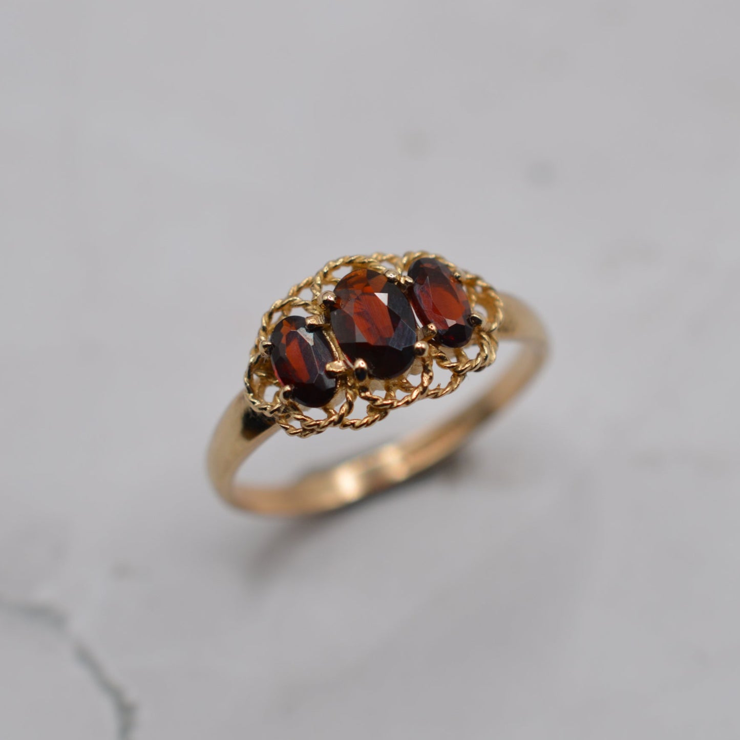 9ct Gold Garnet Trilogy Ring with Rope-Twist Frame