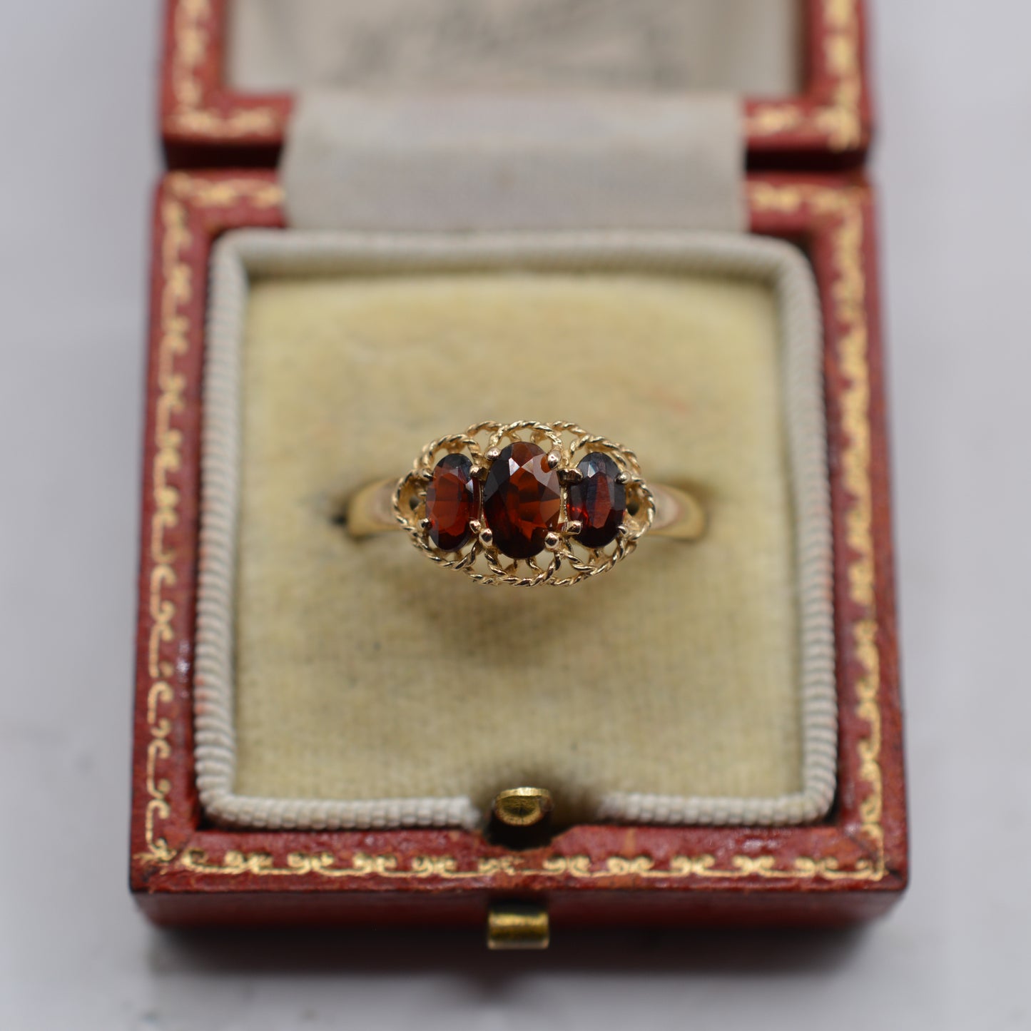 9ct Gold Garnet Trilogy Ring with Rope-Twist Frame