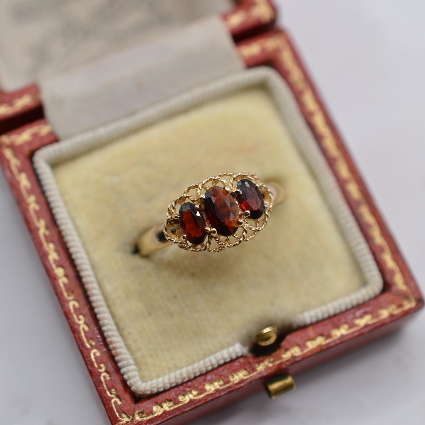 9ct Gold Garnet Trilogy Ring with Rope-Twist Frame